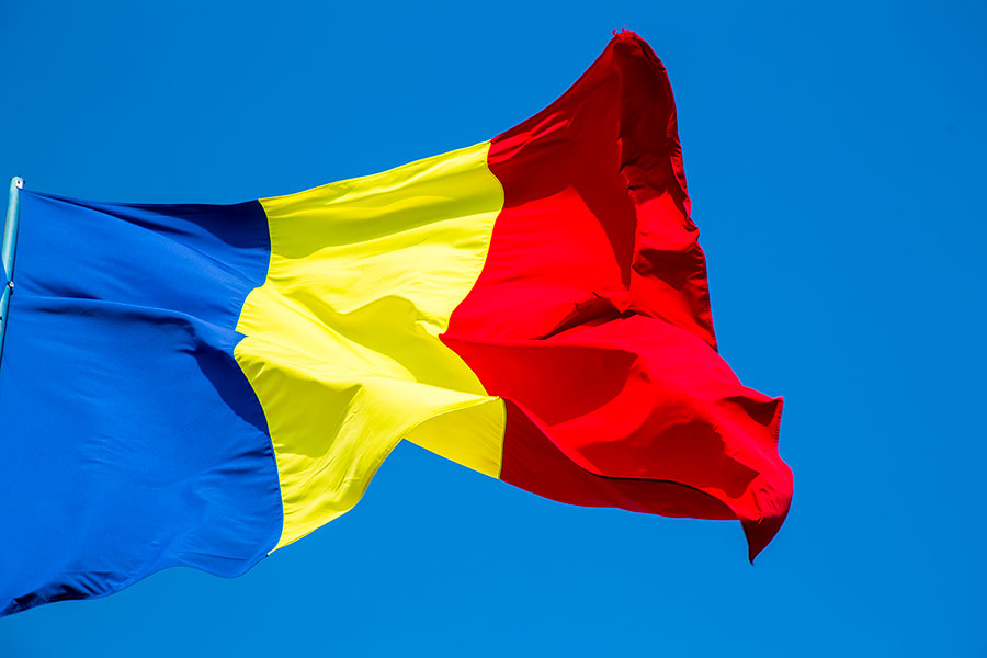 Romanian flag against the blue sky